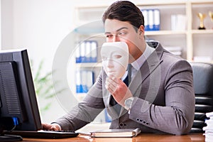 The businessman with mask in office hypocrisy concept