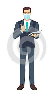 Businessman with medical mask with pen and pocketbook. Full length portrait of Businessman in a flat style photo