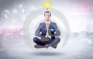 Businessman meditates with enlightenment concept