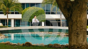 Businessman Meditating Doing Yoga Outside Office Building