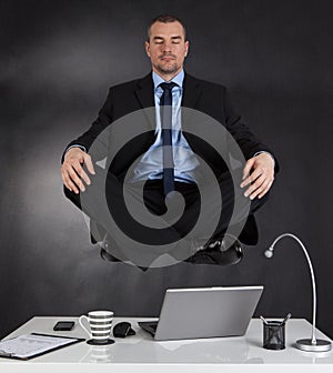 Businessman meditating in the office