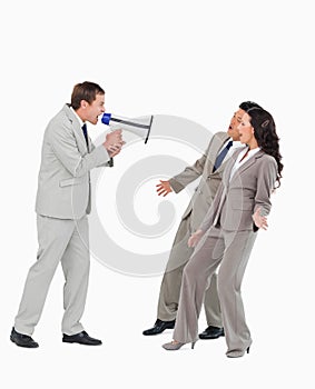 Businessman with megaphone yelling at associates