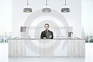 Businessman at modern reception desk