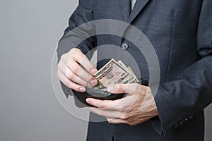 Businessman with money in purse in hands