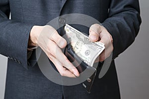 Businessman with money in purse in hands