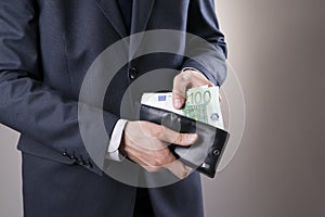 Businessman with money in purse in hands