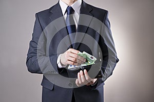 Businessman with money in purse in hands