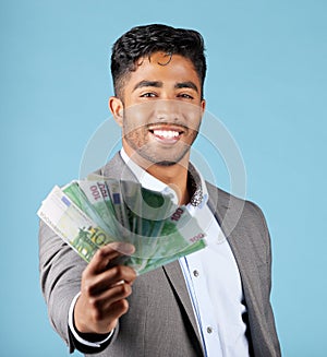 Businessman, money and rich with cash, income and happy with profit, salary and finance currency in blue mockup studio