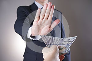 Businessman with money in studio. Corruption concept. Hundred dollar bills photo