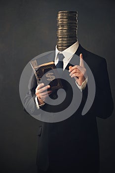 Businessman with moral pointing finger and handbook for making m