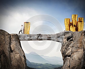 Businessman moves a pile of coins to a moneybox. concept of difficulty to saving money