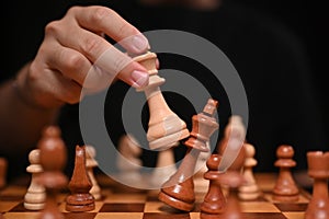 Businessman moving chess piece and checkmate during competition. Successful business competition concept.