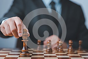 Businessman moving chess piece on chess board game concept for ideas and competition