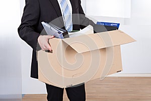 Businessman moving out with cardboard box