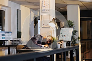 Businessman napping on desk because of overwork