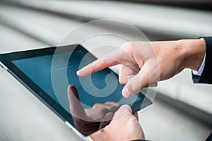 Businessman navigating on a tablet computer