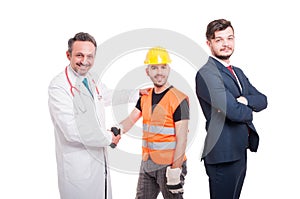 Businessman near medic and engineer offering handshake