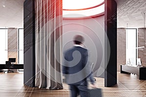 Businessman near round futuristic meeting room