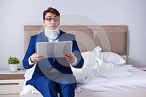 The businessman with neck injury working from home