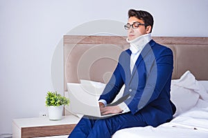 The businessman with neck injury working from home