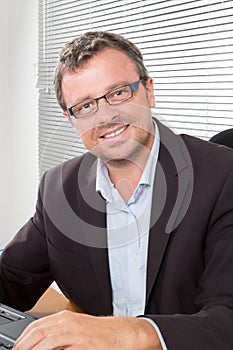 businessman networking in office smiling at camera