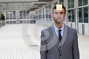 Businessman with a note on his forehead