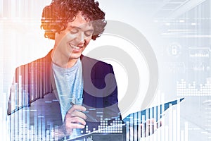 Businessman with notebook in hands, digital icons and graphs