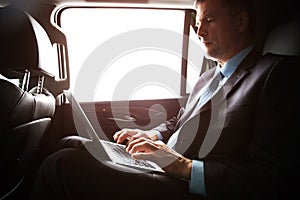 Businessman with notebook sitting inside an airplane