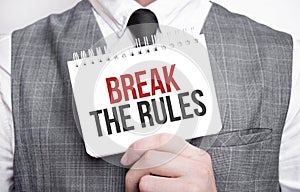 Businessman with notebook with text Break the Rules
