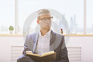 Businessman with notepad and smartphone