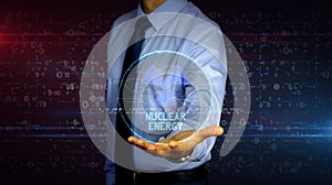 Businessman with nuclear energy symbol hologram