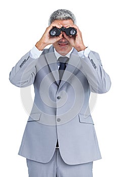 Businessman observing through binoculars