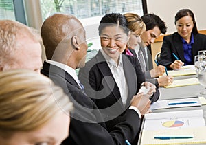 Businessman offering business card to colleague photo