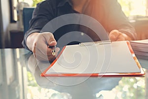 Businessman offering contract paper to his business partner for sign contract