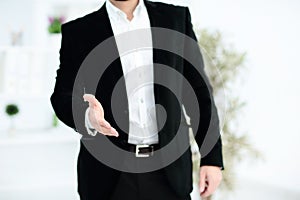 Businessman offering his hand for handshake. Greeting or congratulating gesture. Business meeting and success