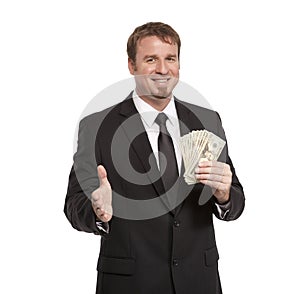 Businessman offers handshake with money