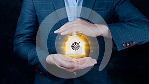 Businessman offers wooden house between his hands with aiming goal icon Action plan,success and business target concept,company