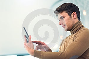 Businessman in office building holding digital tablet