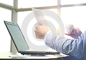 Businessman in the office deals with matters in the morning with a cup of coffee