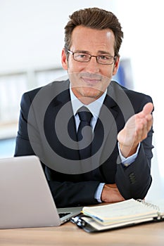 Businessman at office giving advice to business partner