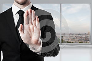 Businessman in office hand stop gesture