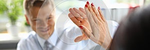 Businessman in an office high five of his colleague a closeup.