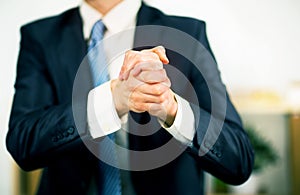 Businessman at the office with his hands folded