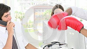 Businessman in office messing with boxing gloves