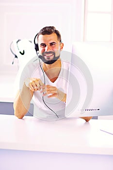 Businessman in the office on the phone with headset, Skype