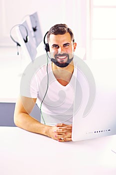 Businessman in the office on the phone with headset, Skype