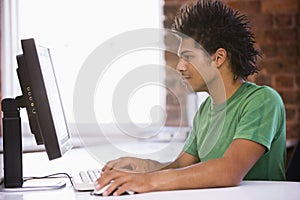 Businessman in office typing on computer