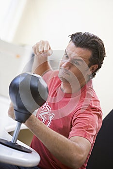 Businessman in office using small punching bag