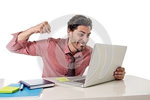 Businessman at office working stressed on computer laptop overworked throwing punch in work stress