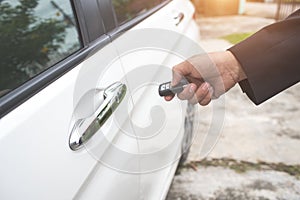 Businessman open car door